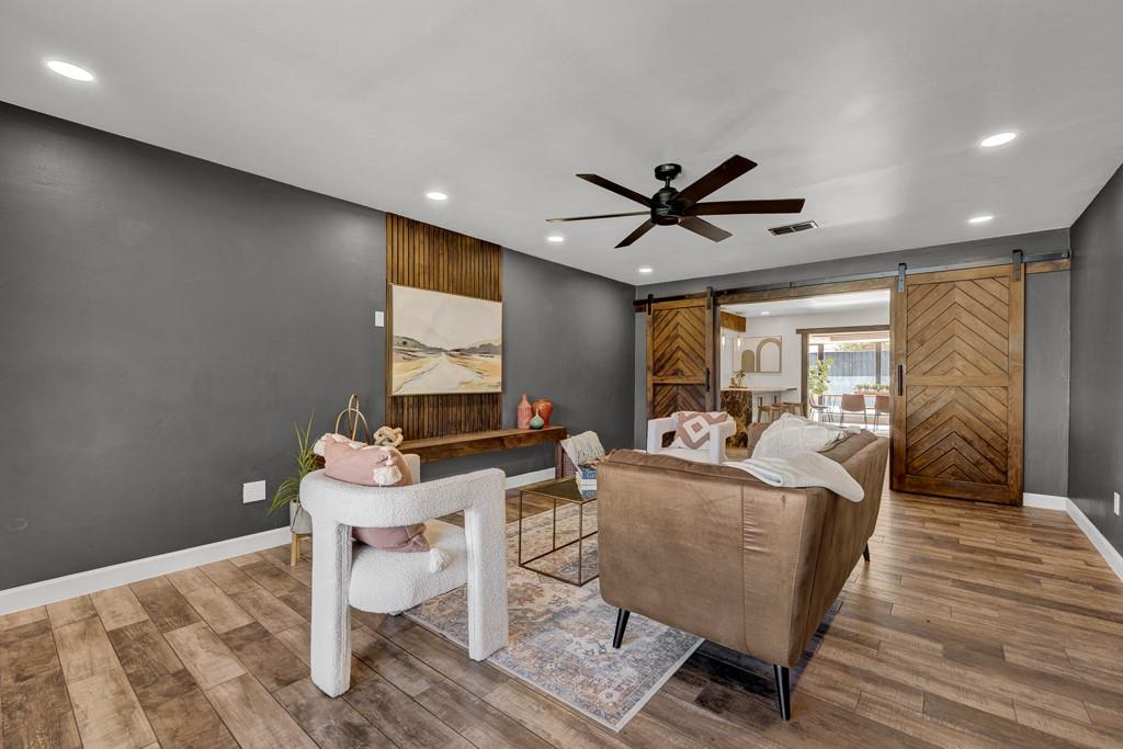 6117 Gainsborough Road Amarillo, TX 79106 - Photo 2 of 40 a living room with furniture a ceiling fan and a rug