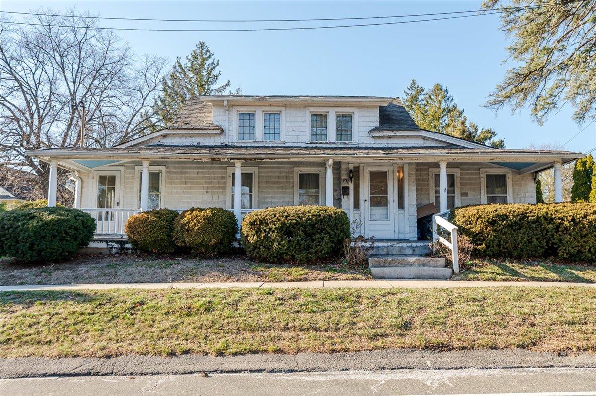 a view of a house with a chairs in front of a house