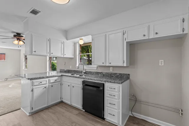 a kitchen with a sink stove and cabinets
