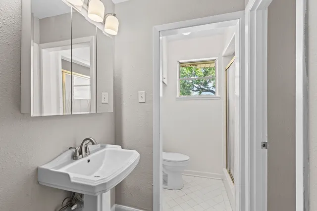 a bathroom with a sink a mirror and a toilet