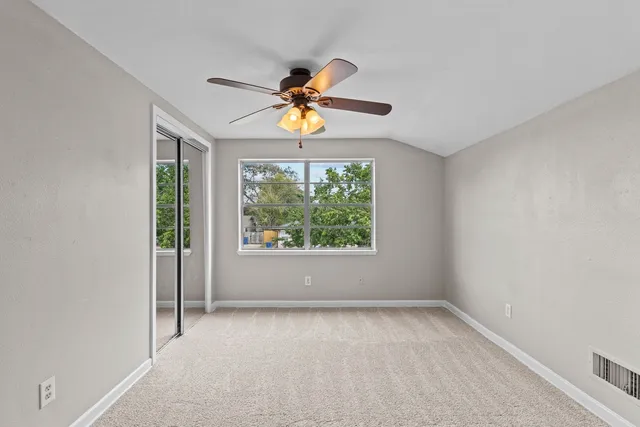 a view of room with window and ceiling fan