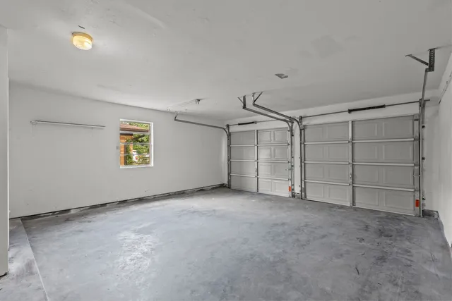 an empty room with a empty space and windows