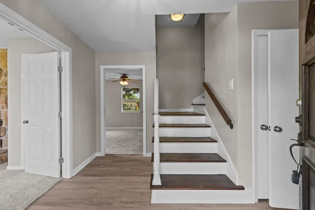 a view of a hallway with wooden floor and entryway