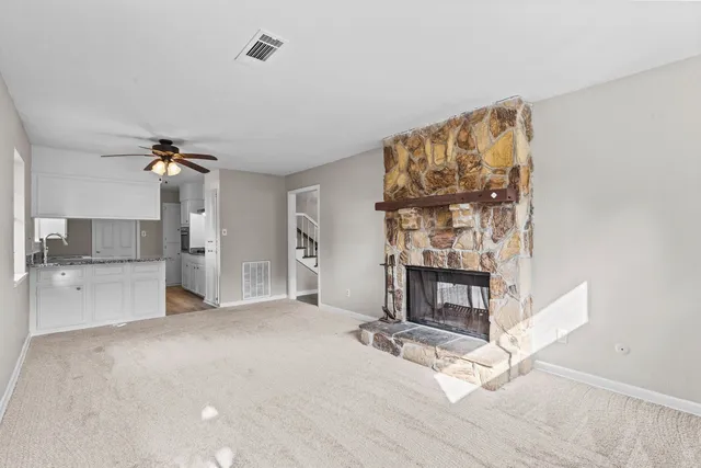 a view of an empty room and fire place