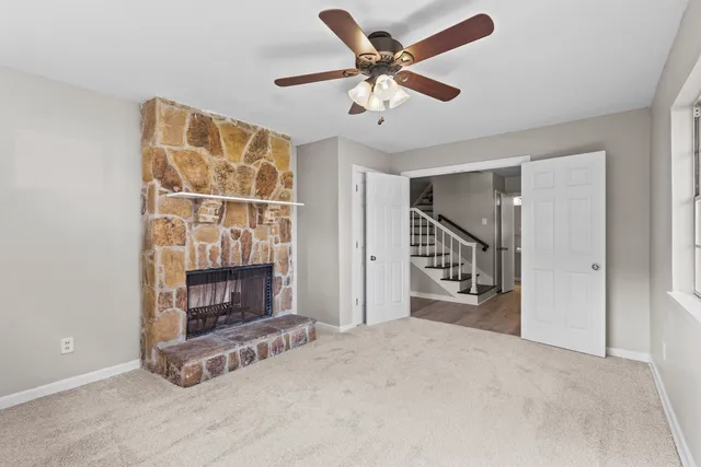 a view of an empty room with a fireplace