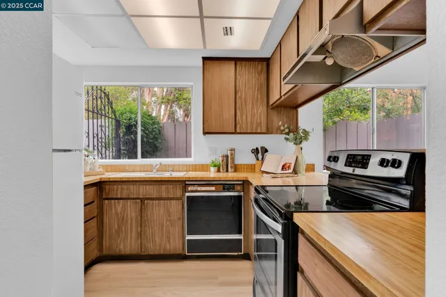 a kitchen that has a sink a stove and a microwave