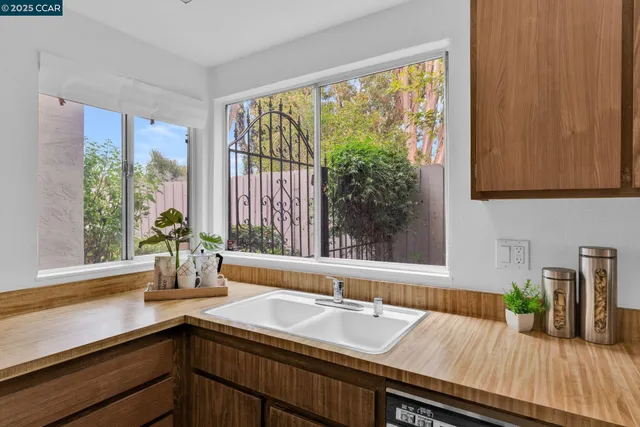 a kitchen with a sink and large window