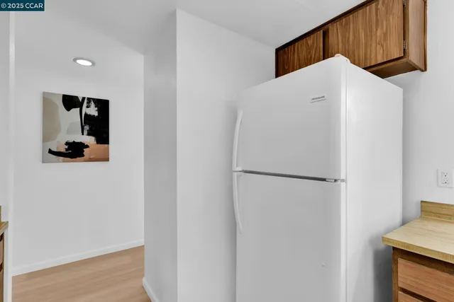 a white refrigerator freezer sitting in a kitchen