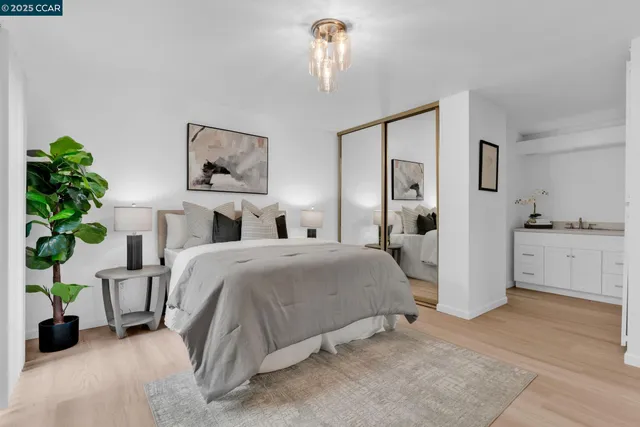 a bedroom with a bed and a chandelier