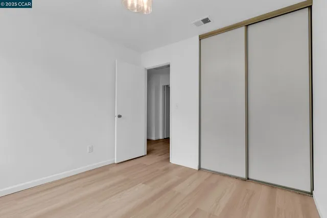 a view of a room with wooden floor and a window