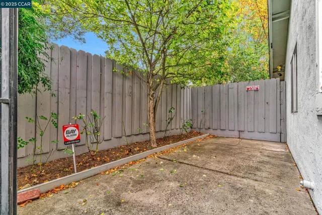 a view of a street with wooden fence