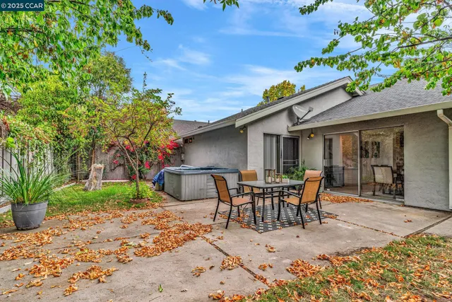 a view of a house with patio and a yard