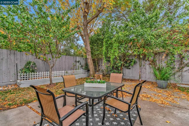 a backyard of a house with table and chairs