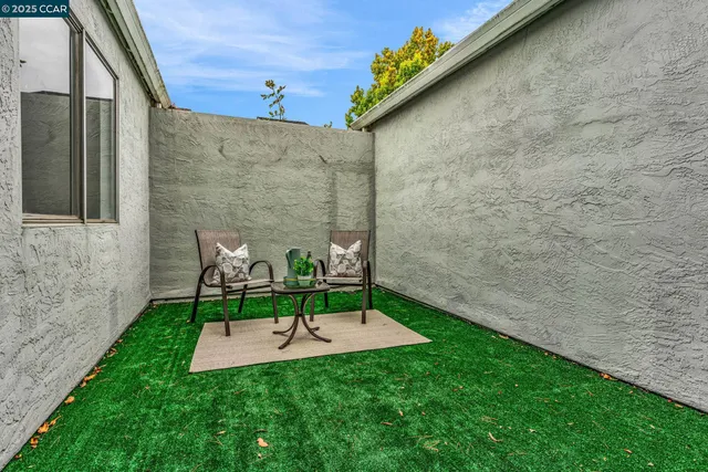 a view of a backyard with table and chairs