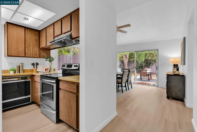 a kitchen with stainless steel appliances granite countertop a stove and a refrigerator
