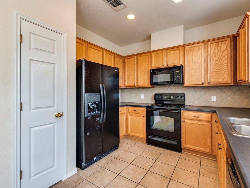 6 Verde Ranch Loop Leander, TX 78641 - Photo 9 of 24 a kitchen with stainless steel appliances granite countertop a refrigerator and a stove top oven