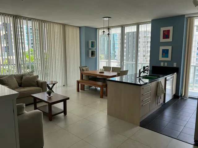 a kitchen with a sink and a refrigerator