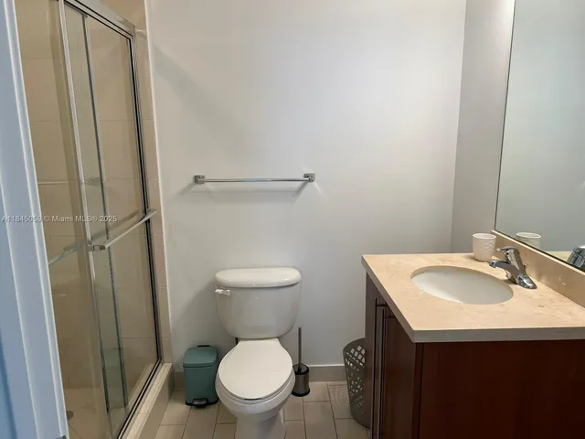 a white toilet sitting next to a bathroom sink