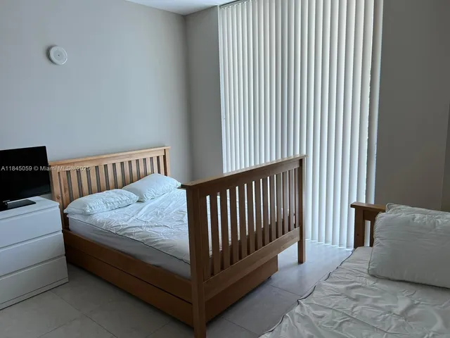 a bed room with a bed and a television