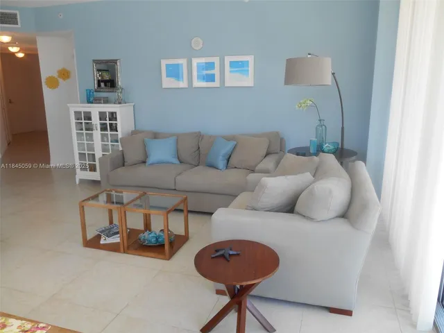 a living room with furniture and a lamp