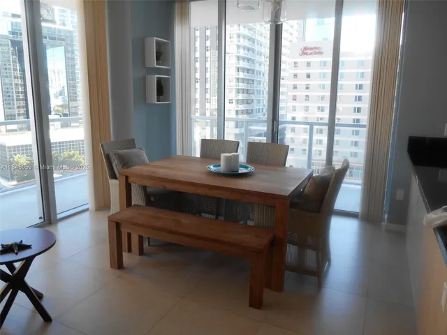 a dining room with furniture and window