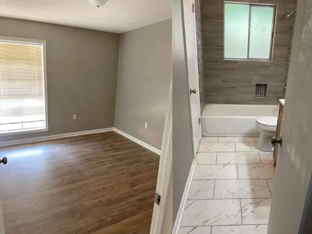 a bathroom with a bathtub and toilet