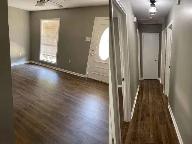 a view of a hallway with wooden floor and stairs