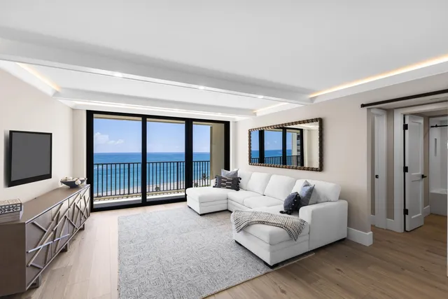 a bedroom with furniture and large window