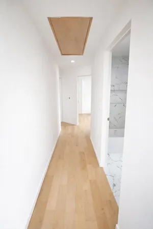 a hallway with sliding door and couch