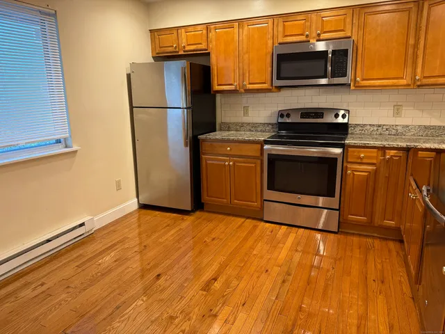 a kitchen with a refrigerator stove and microwave
