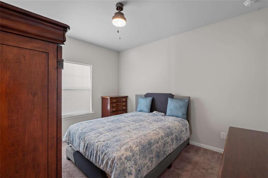 9068 Jim Purcell Drive Covington, GA 30014 - Photo 35 of 48 a bedroom with a large bed and a closet