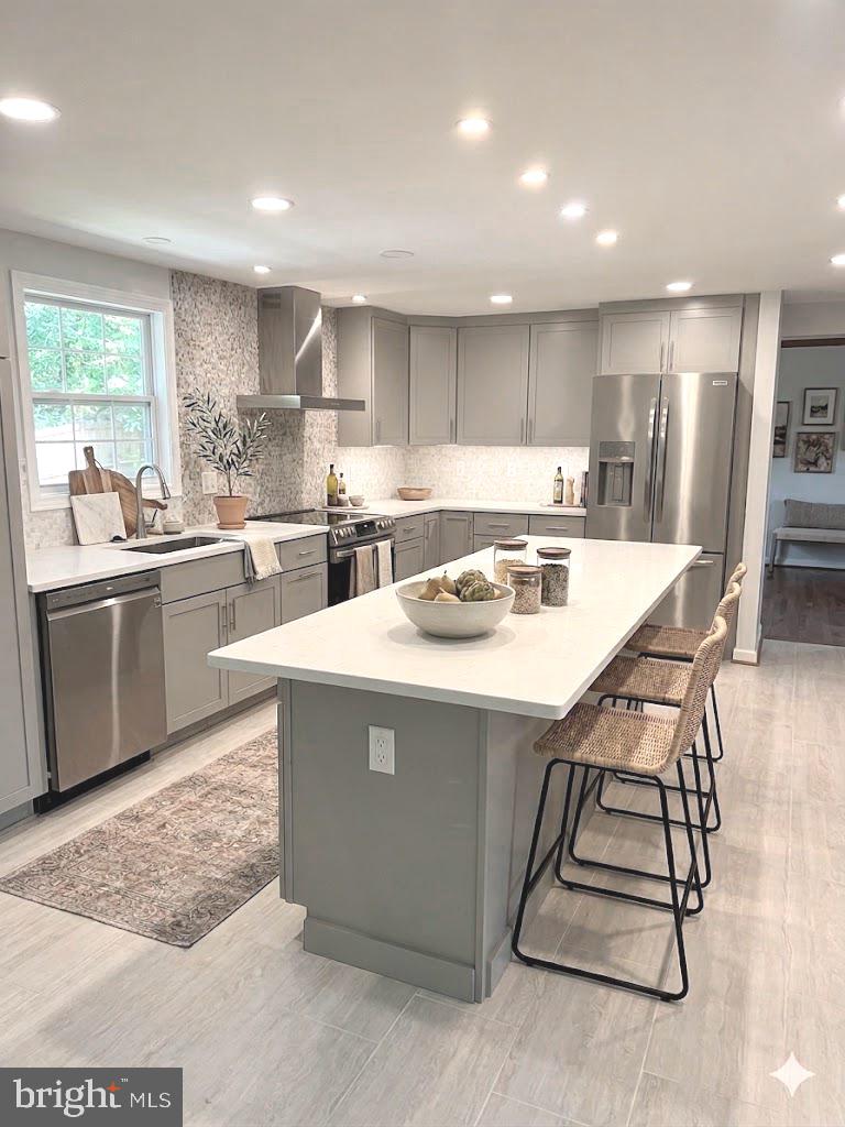 2283 Dosinia Court Reston, VA 20191 - Photo 3 of 28 a kitchen with kitchen island a stove a sink a refrigerator and white cabinets with wooden floor