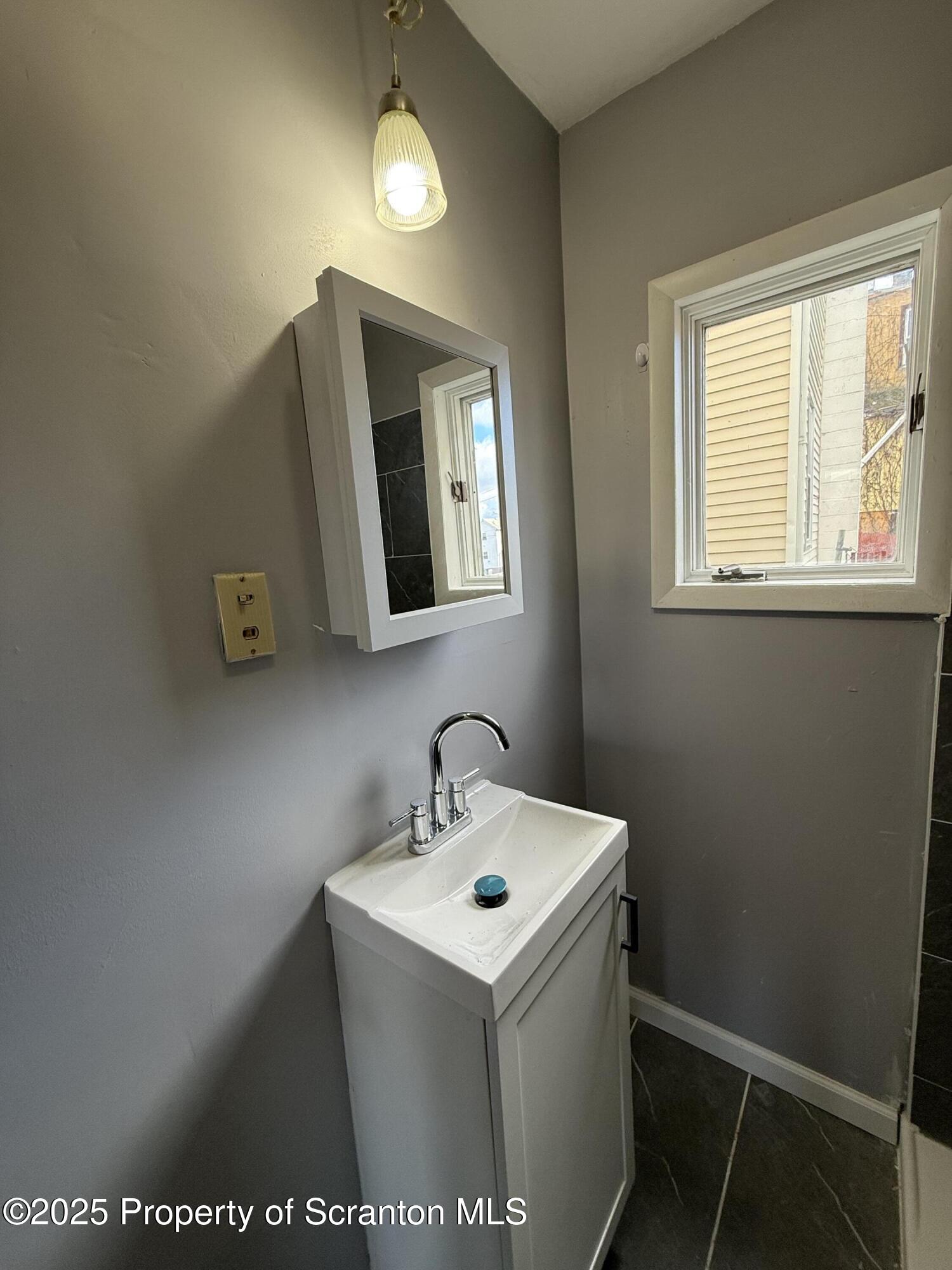 1706 Prospect Avenue, Unit REAR Scranton, PA 18505 - Photo 12 of 18 a bathroom with a sink and a mirror