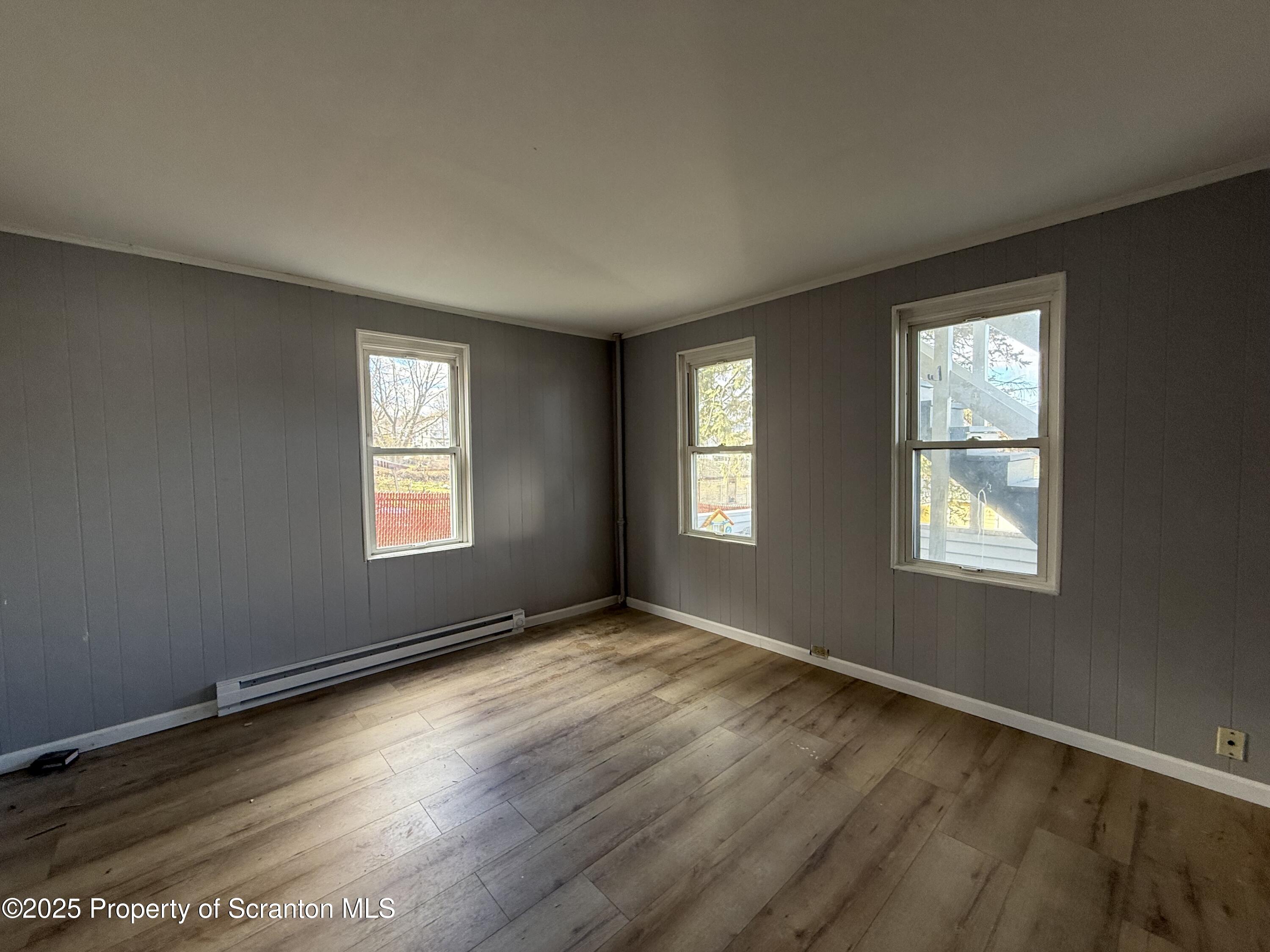1706 Prospect Avenue, Unit REAR Scranton, PA 18505 - Photo 15 of 18 a view of an empty room with wooden floor and a window