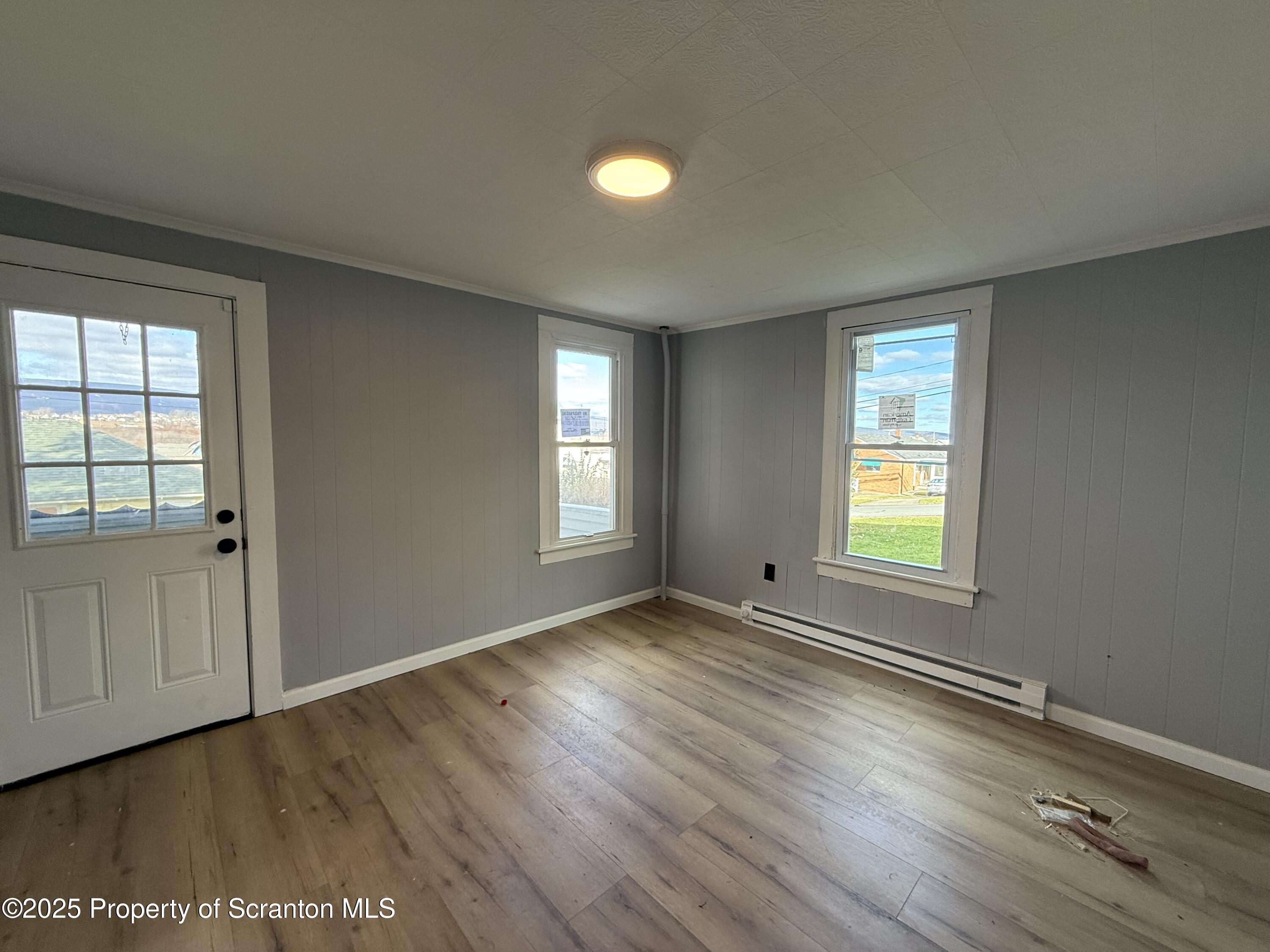 1706 Prospect Avenue, Unit REAR Scranton, PA 18505 - Photo 16 of 18 an empty room with wooden floor and windows