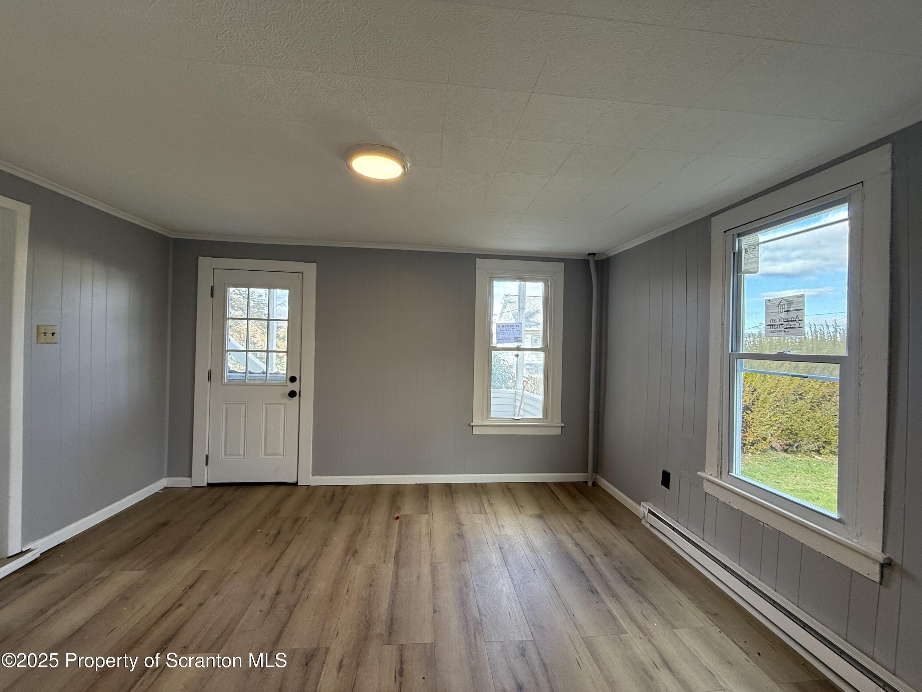 1706 Prospect Avenue, Unit REAR Scranton, PA 18505 - Photo 17 of 18 a view of an empty room with wooden floor and a window