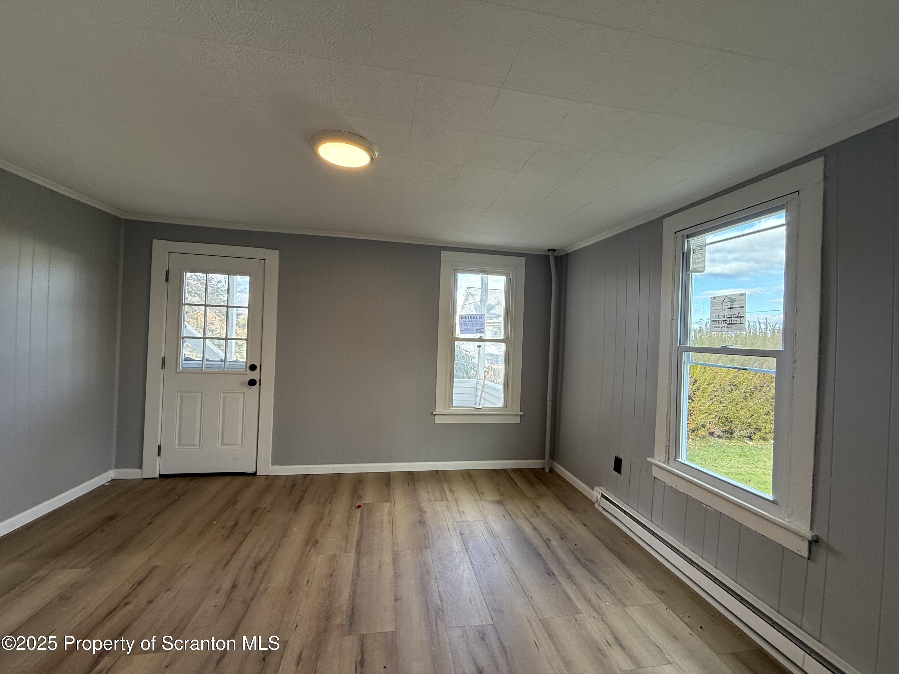 1706 Prospect Avenue, Unit REAR Scranton, PA 18505 - Photo 18 of 18 an empty room with wooden floor and windows