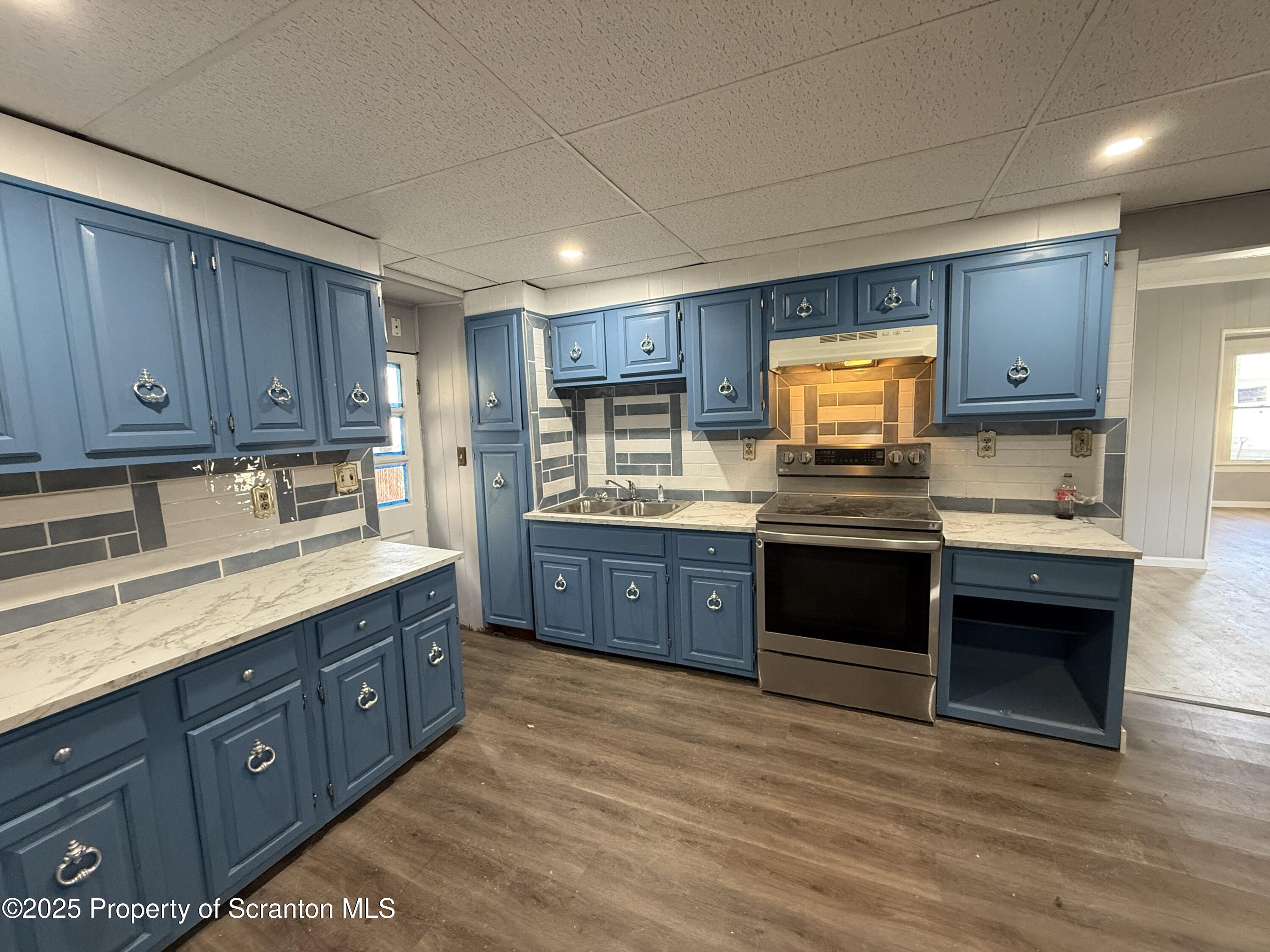 1706 Prospect Avenue, Unit REAR Scranton, PA 18505 - Photo 2 of 18 a open kitchen with stainless steel appliances granite countertop a stove a sink dishwasher and a refrigerator