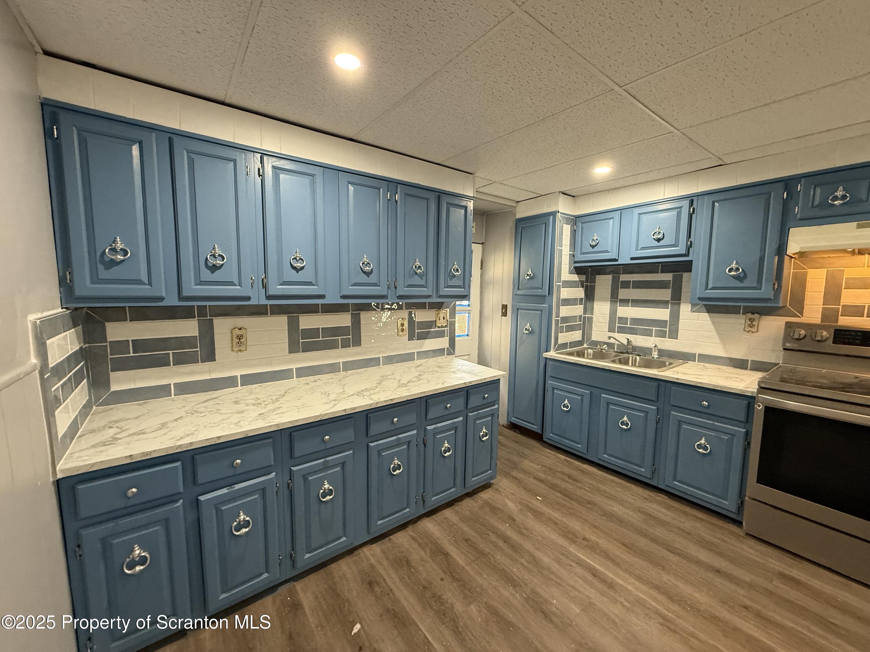 1706 Prospect Avenue, Unit REAR Scranton, PA 18505 - Photo 3 of 18 a kitchen with stainless steel appliances granite countertop a sink a stove and cabinets