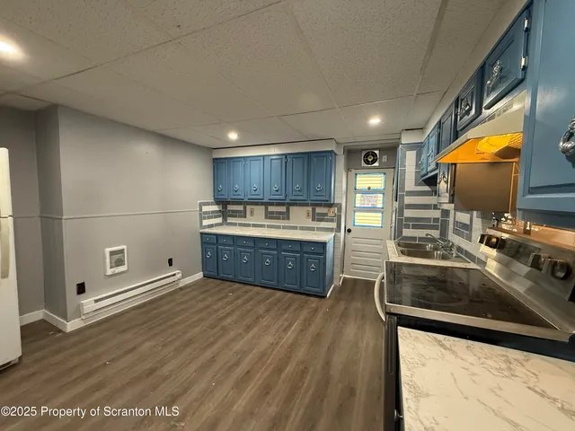 a kitchen with stainless steel appliances granite countertop a sink stove and wooden cabinets