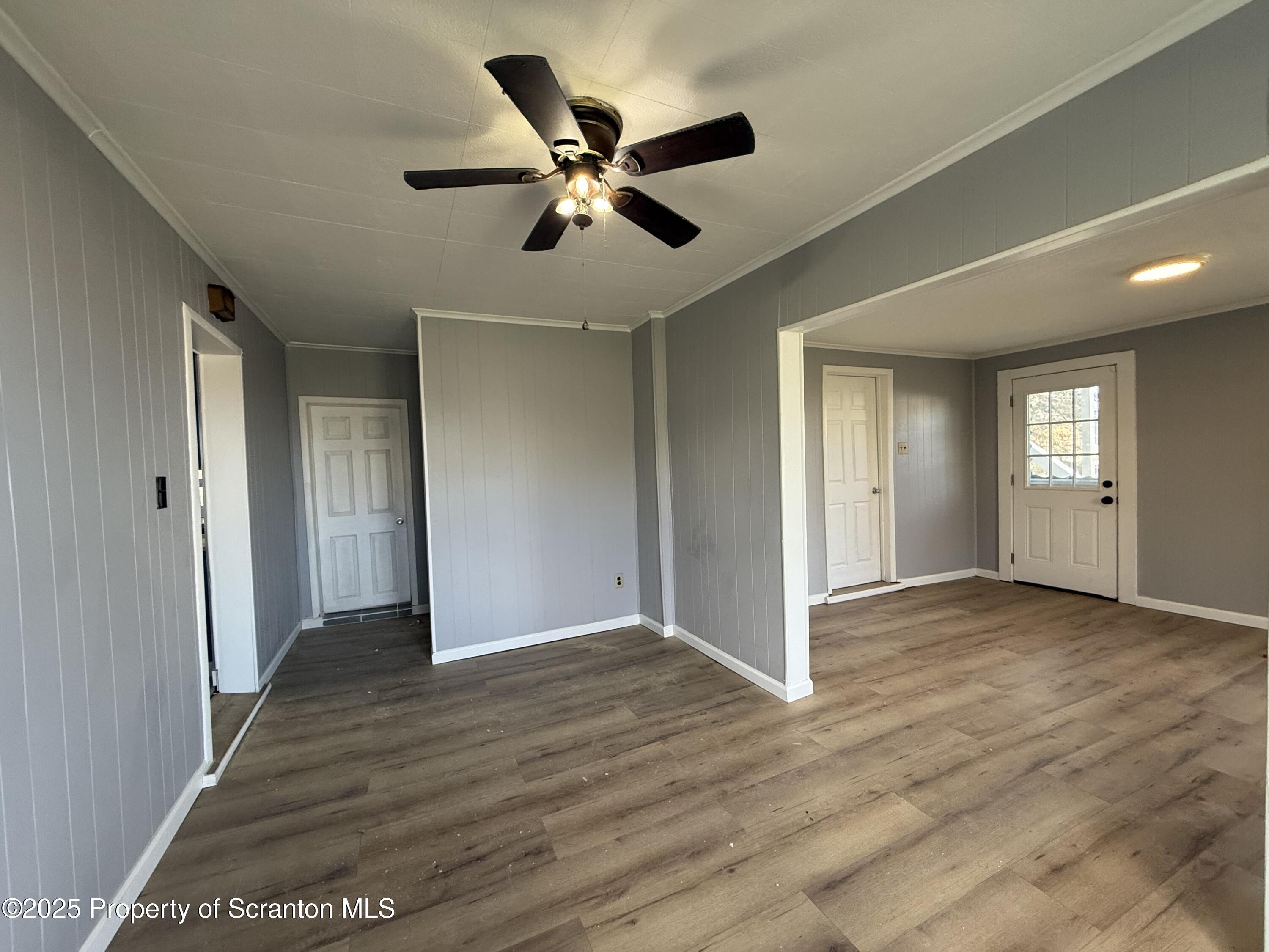1706 Prospect Avenue, Unit REAR Scranton, PA 18505 - Photo 7 of 18 a view of an empty room with wooden floor and a ceiling fan
