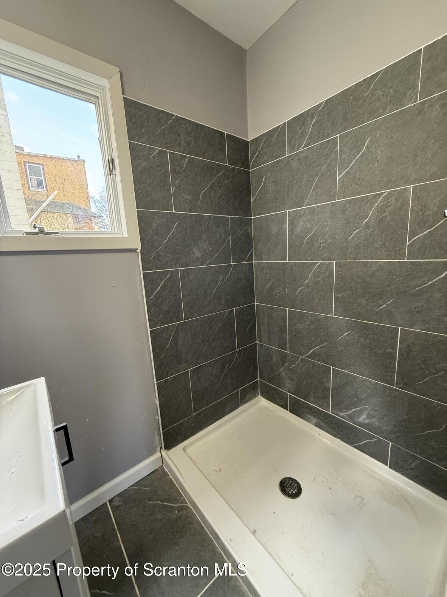 1706 Prospect Avenue, Unit REAR Scranton, PA 18505 - Photo 8 of 18 a bathroom with a bath tub