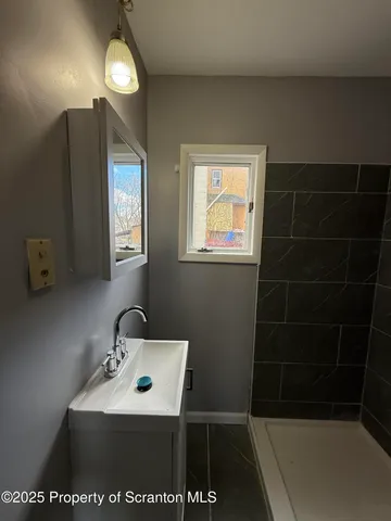 a bathroom with a sink a toilet and mirror