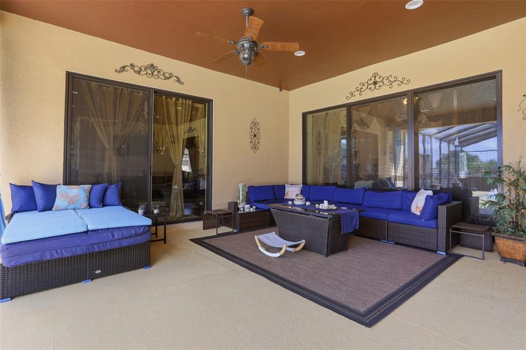 13429 Montevista Road Clermont, FL 34711 - Photo 56 of 89 a living room with furniture and a chandelier