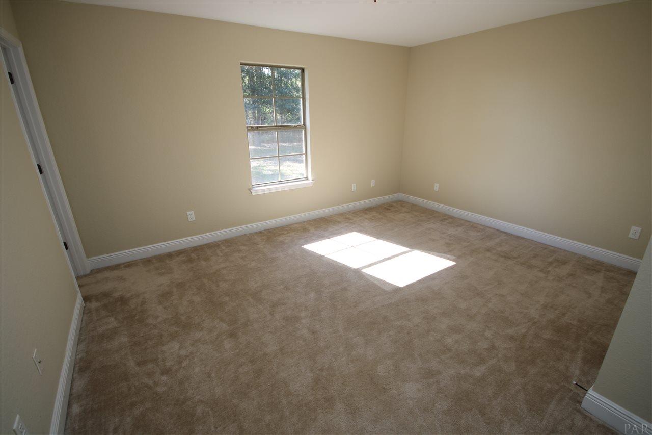 9995 Nichols Lake Road Milton, FL 32583 - Photo 42 of 50 This bedroom has an attached bath.