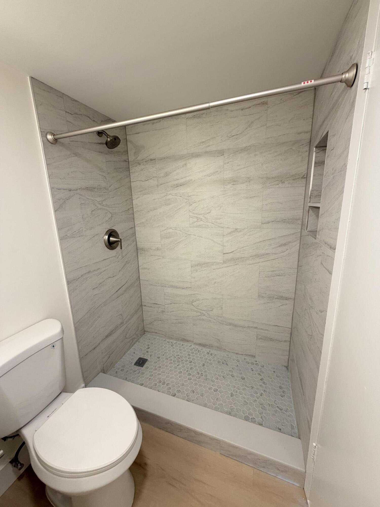 37 Suffolk Way Boca Raton, FL 33434 - Photo 11 of 40 a bathroom with a shower and a toilet