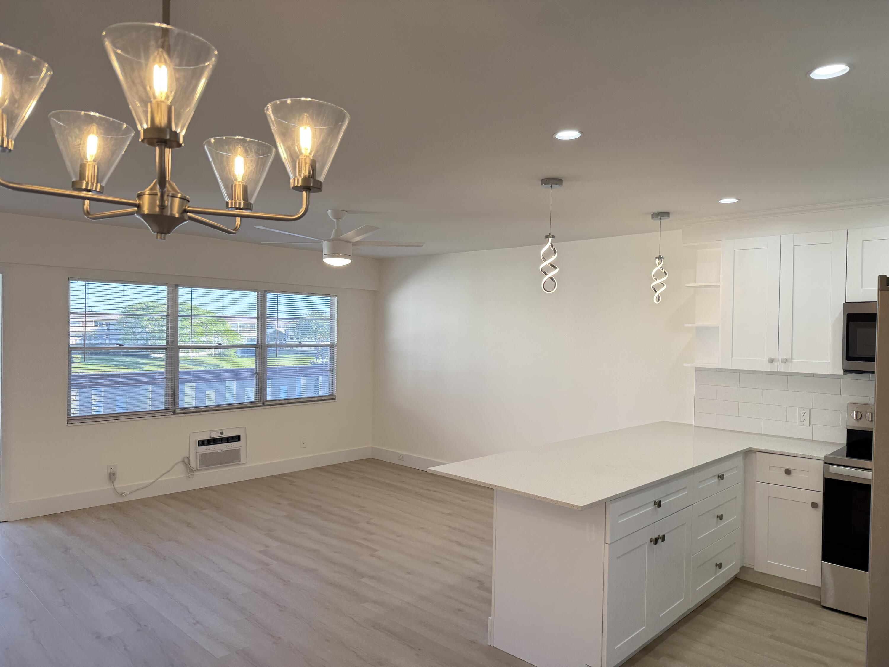 37 Suffolk Way Boca Raton, FL 33434 - Photo 33 of 40 an empty room with wooden floor and windows