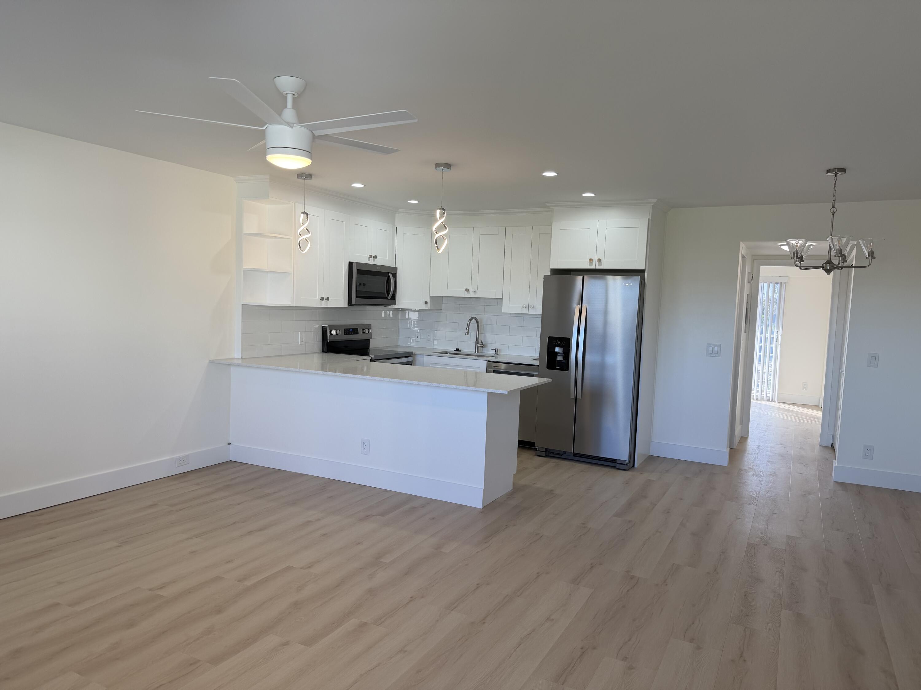 37 Suffolk Way Boca Raton, FL 33434 - Photo 34 of 40 a kitchen with stainless steel appliances a refrigerator and a microwave