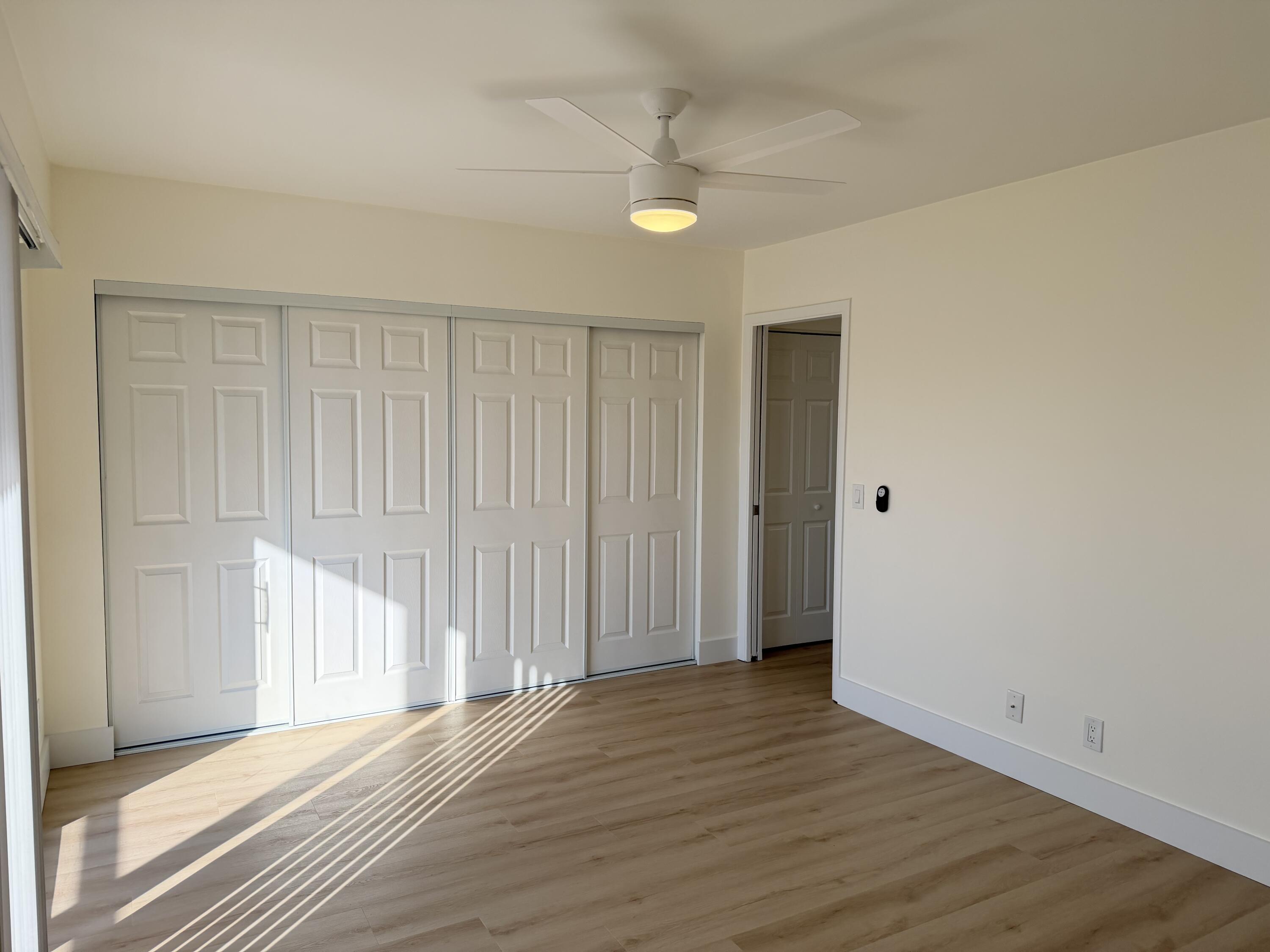 37 Suffolk Way Boca Raton, FL 33434 - Photo 38 of 40 a view of a room with wooden floor and a ceiling fan