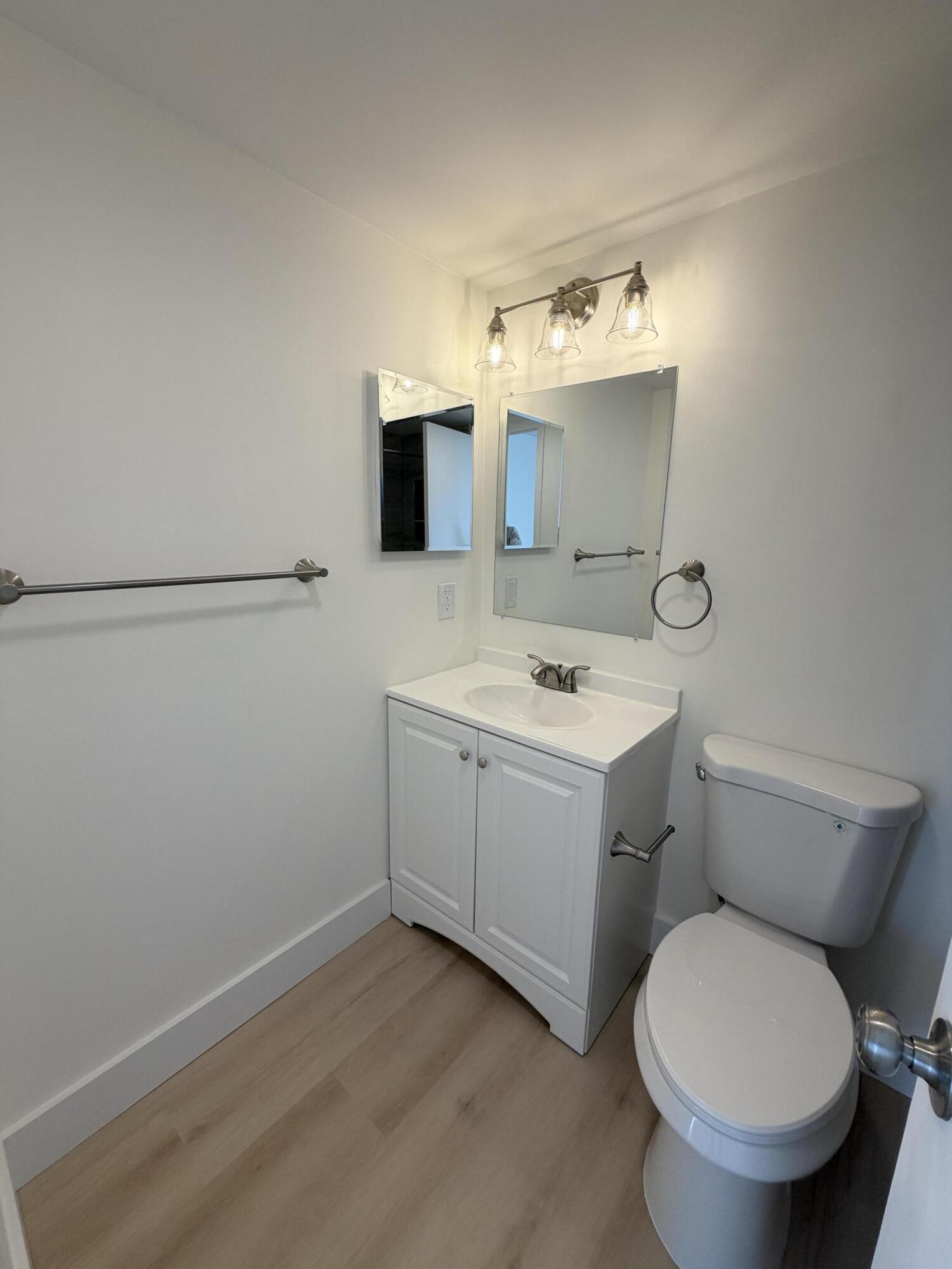 37 Suffolk Way Boca Raton, FL 33434 - Photo 10 of 40 a bathroom with a toilet sink and mirror